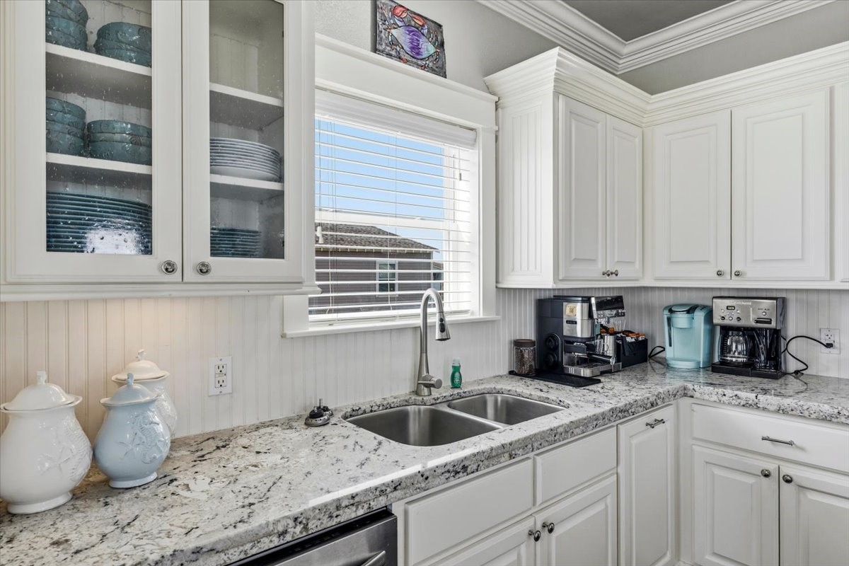 839 Eastview Crystal Beach, TX 77650 - Photo 17 of 44 a kitchen with granite countertop a sink and cabinets