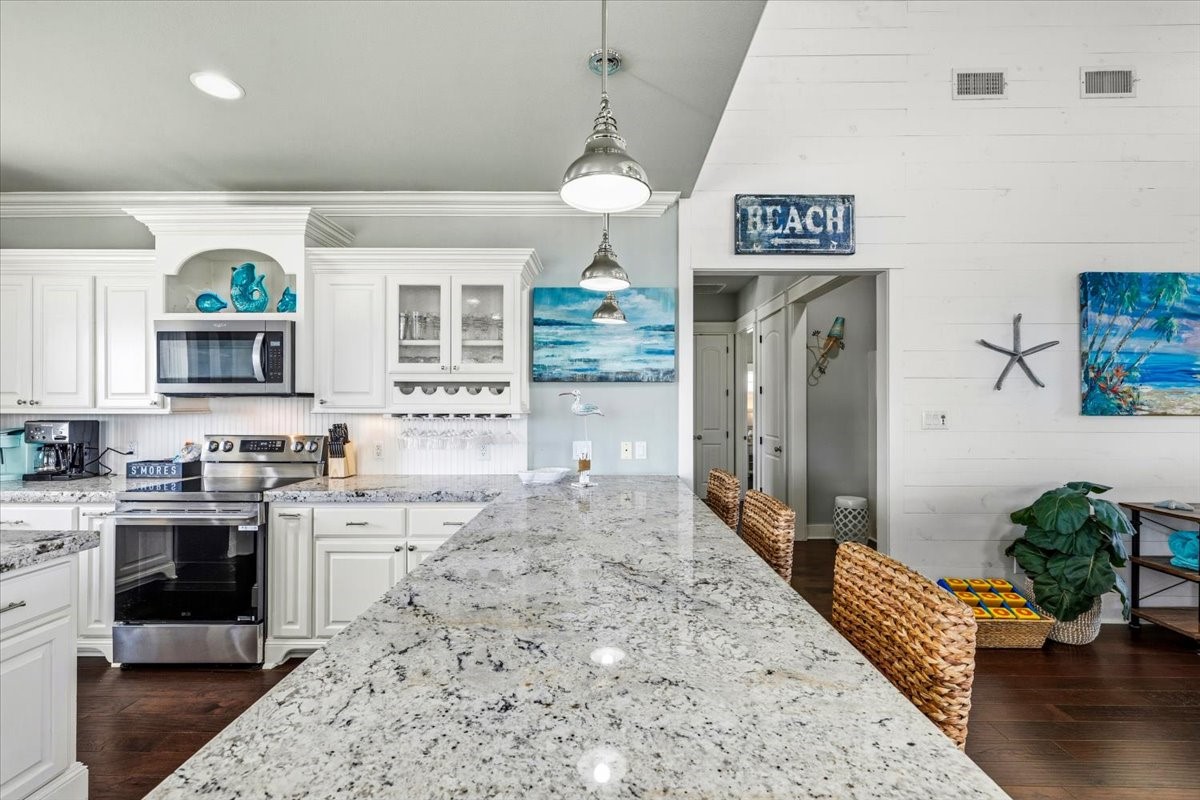 839 Eastview Crystal Beach, TX 77650 - Photo 20 of 44 a kitchen with stainless steel appliances granite countertop a stove and cabinets