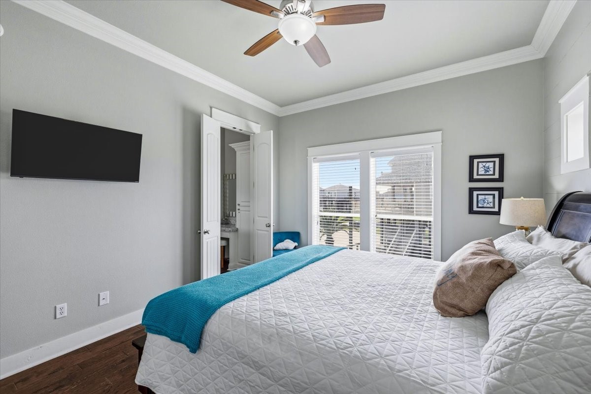 839 Eastview Crystal Beach, TX 77650 - Photo 28 of 44 a bedroom with a bed and a flat screen tv