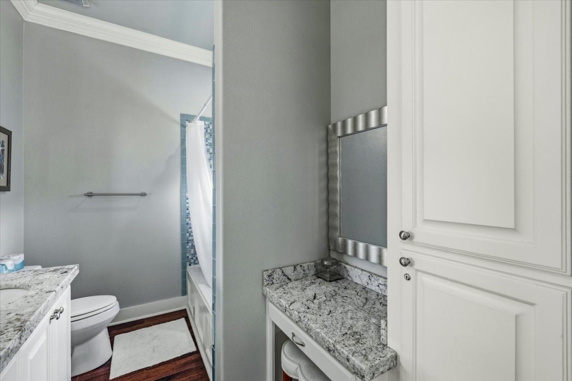 839 Eastview Crystal Beach, TX 77650 - Photo 30 of 44 a bathroom with a granite countertop sink and a toilet