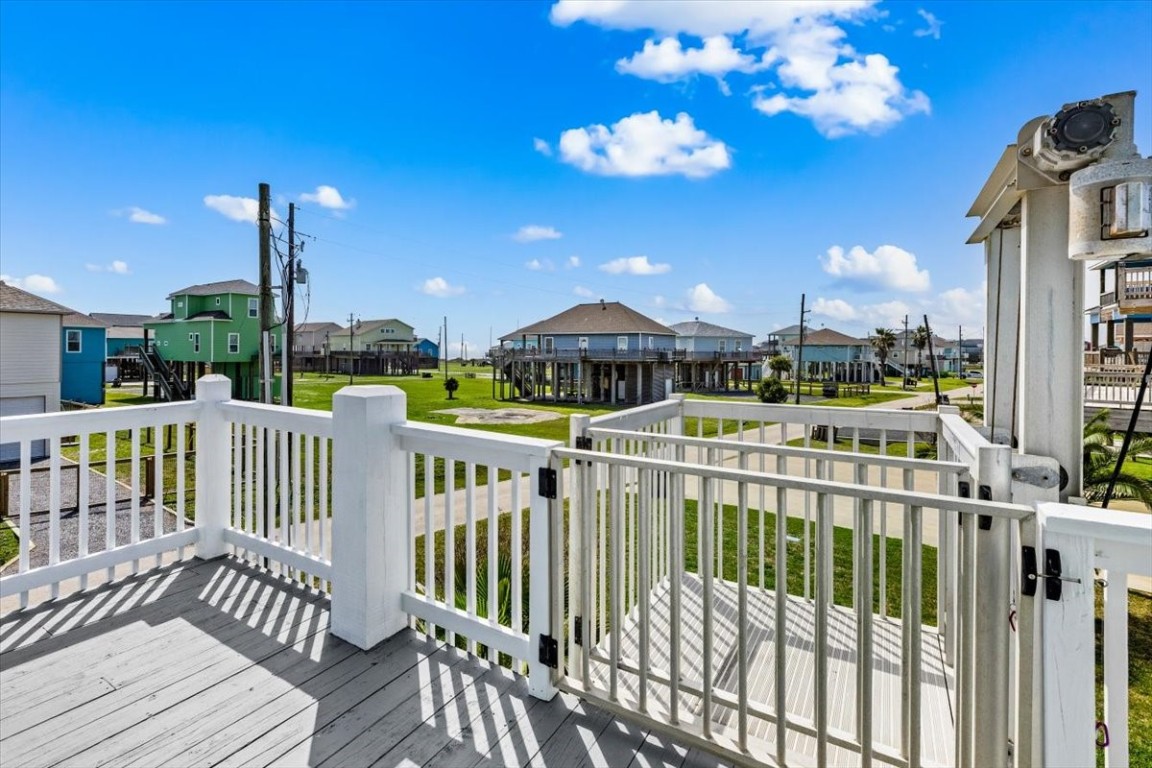 839 Eastview Crystal Beach, TX 77650 - Photo 3 of 44 a view of a balcony with wooden floor and iron fence