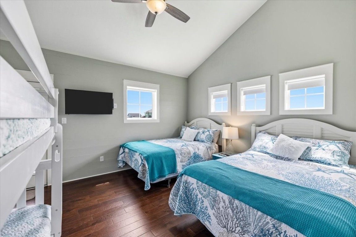 839 Eastview Crystal Beach, TX 77650 - Photo 32 of 44 a bedroom with two beds and a flat screen tv