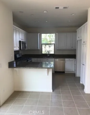 a kitchen with a cabinets and window