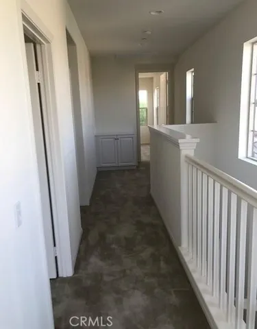 a view of a hallway view with wooden floor and staircase
