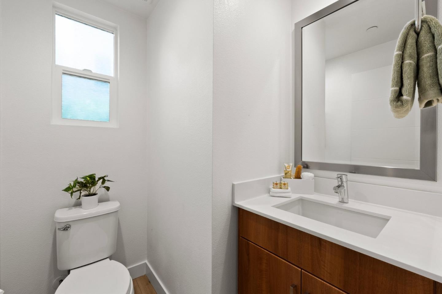117 Uptown Circle Oakland, CA 94607 - Photo 11 of 25 a bathroom with a toilet sink and mirror