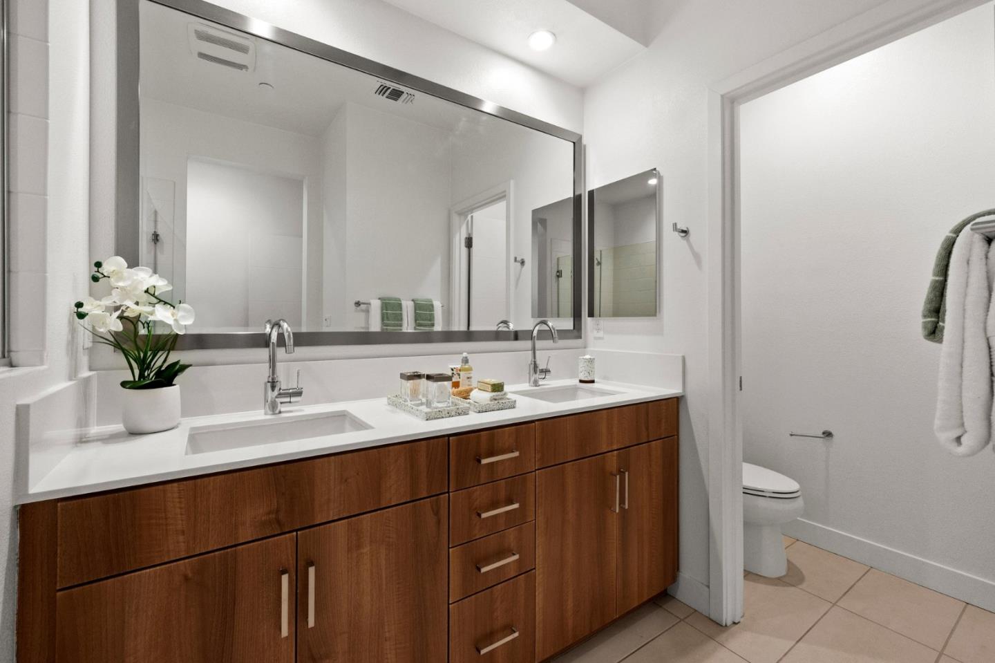 117 Uptown Circle Oakland, CA 94607 - Photo 16 of 25 a bathroom with a double vanity sink toilet and a mirror