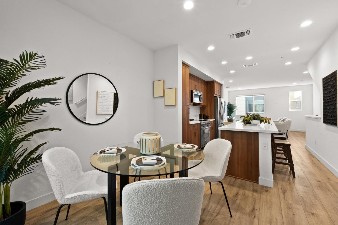 117 Uptown Circle Oakland, CA 94607 - Photo 10 of 25 a dining room with wooden floor a glass table and chairs