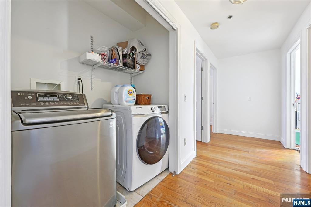 15 Tichenor Street, Unit 407 Newark, NJ 07102 - Photo 15 of 26 a utility room with dryer washer and a view of living room