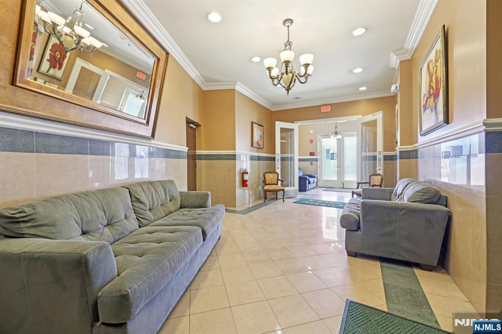 15 Tichenor Street, Unit 407 Newark, NJ 07102 - Photo 4 of 26 a living room with furniture and a chandelier