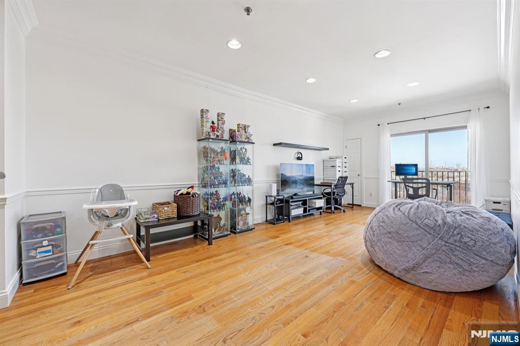 15 Tichenor Street, Unit 407 Newark, NJ 07102 - Photo 9 of 26 a living room with furniture and a wooden floor