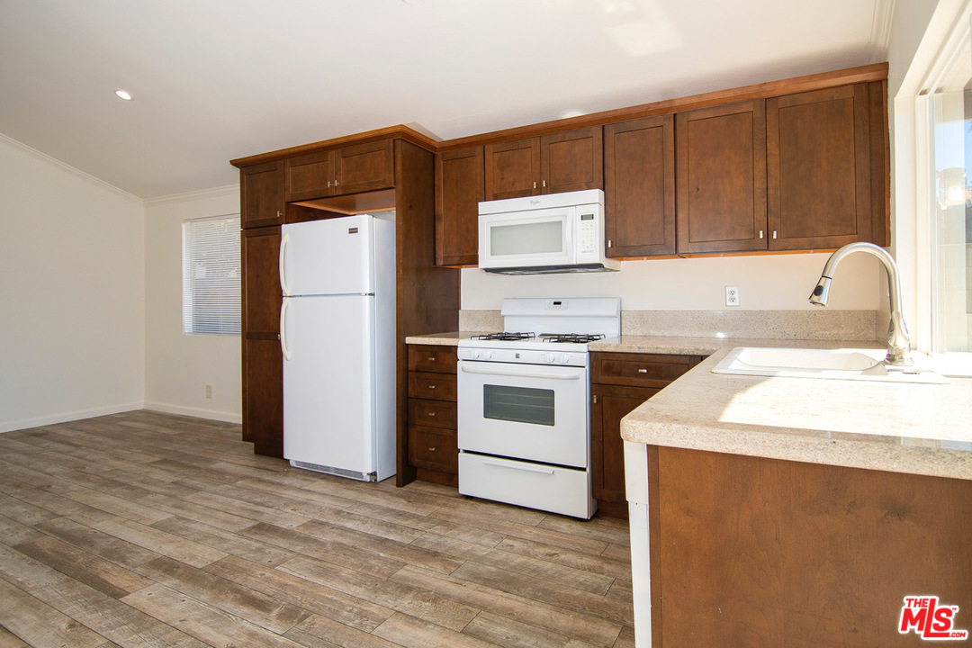 1238 Sultan Circle Carson, CA 90746 - Photo 12 of 18 a kitchen with a sink cabinets and appliances