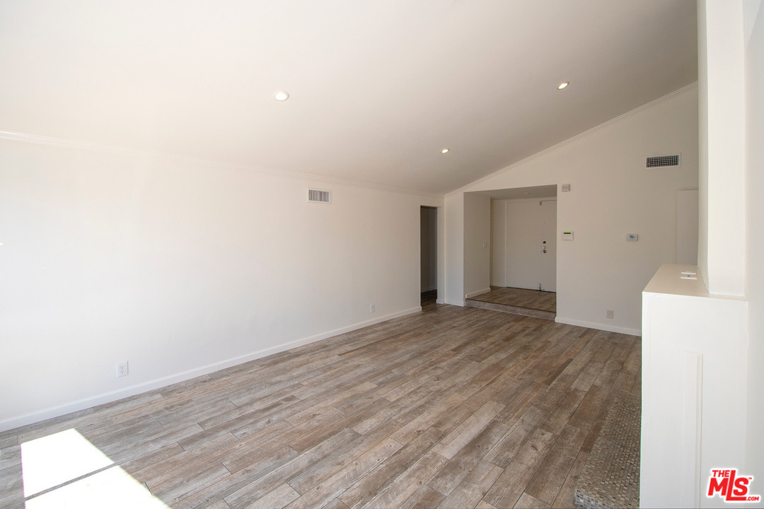 1238 Sultan Circle Carson, CA 90746 - Photo 13 of 18 a view of an empty room with wooden floor
