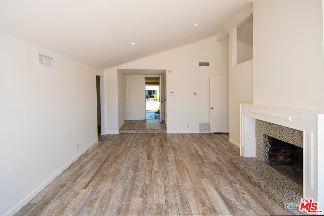 1238 Sultan Circle Carson, CA 90746 - Photo 14 of 18 a view of empty room with wooden floor and fireplace
