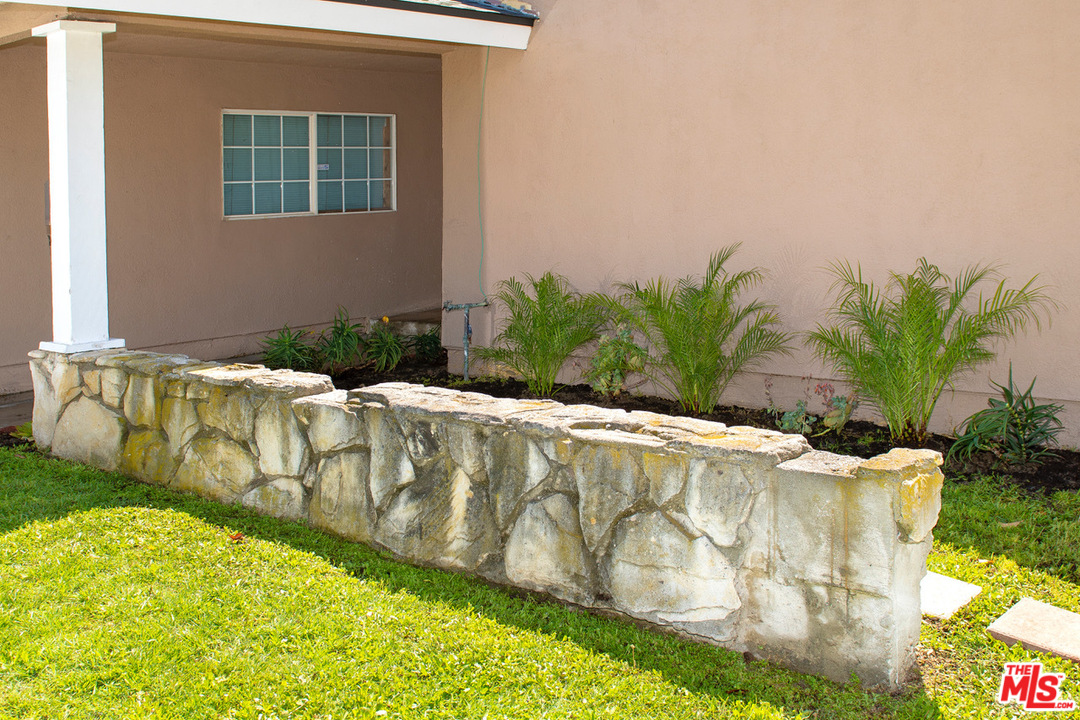 1238 Sultan Circle Carson, CA 90746 - Photo 3 of 18 a white bath tub sitting in a yard next to a blue wall