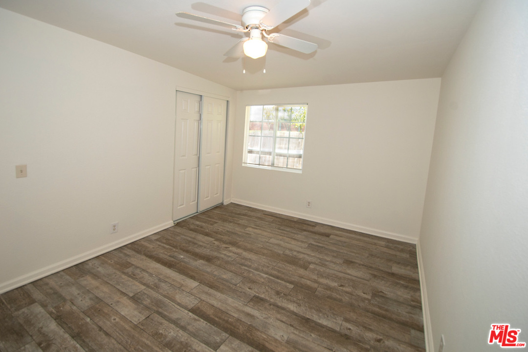 1238 Sultan Circle Carson, CA 90746 - Photo 4 of 18 wooden floor in an empty room with a window