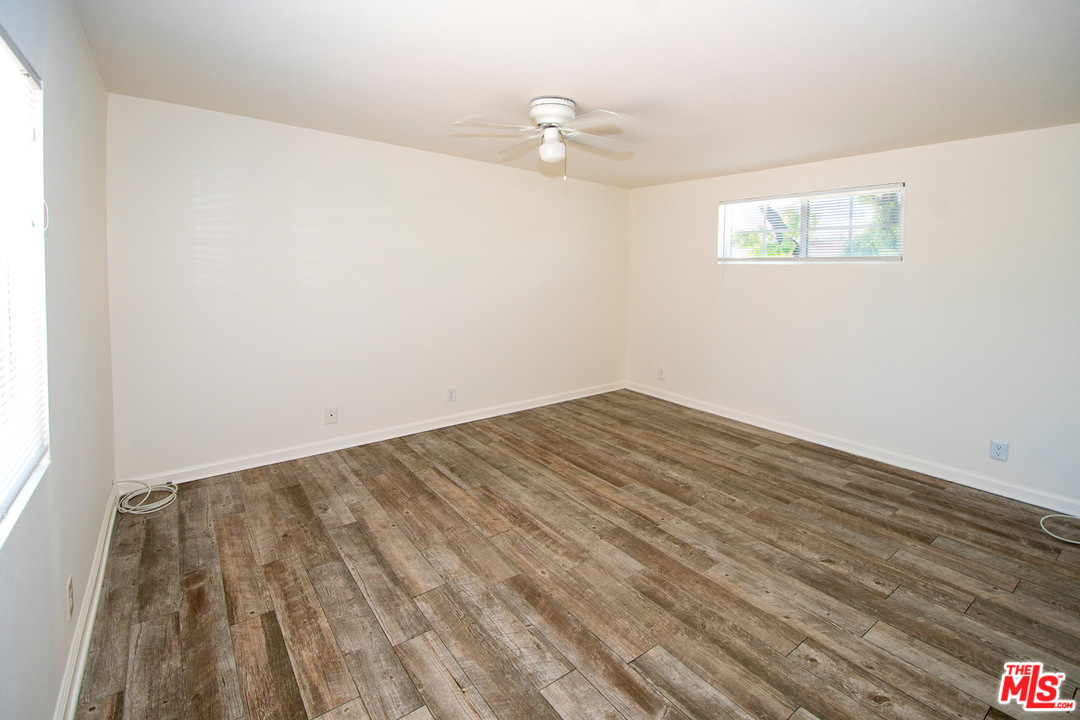 1238 Sultan Circle Carson, CA 90746 - Photo 8 of 18 a view of a room with wooden floor and white walls