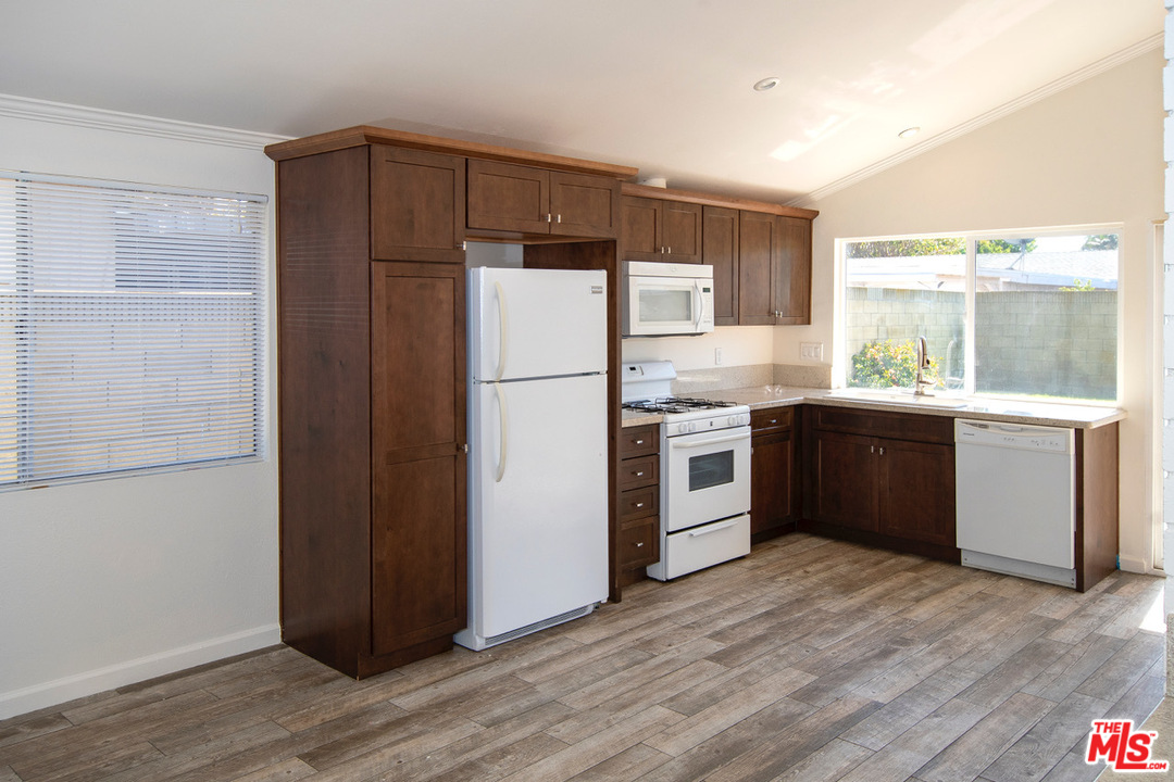 1238 Sultan Circle Carson, CA 90746 - Photo 10 of 18 a kitchen with stainless steel appliances a refrigerator and a stove