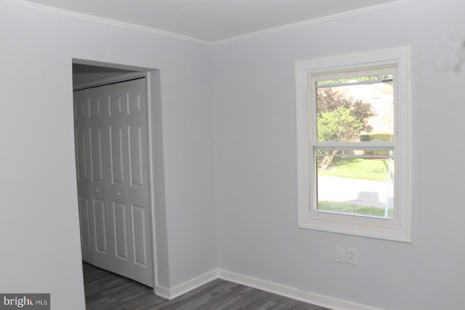 8400 Liberty Road Baltimore, MD 21244 - Photo 12 of 32 a view of an empty room with wooden floor and a window