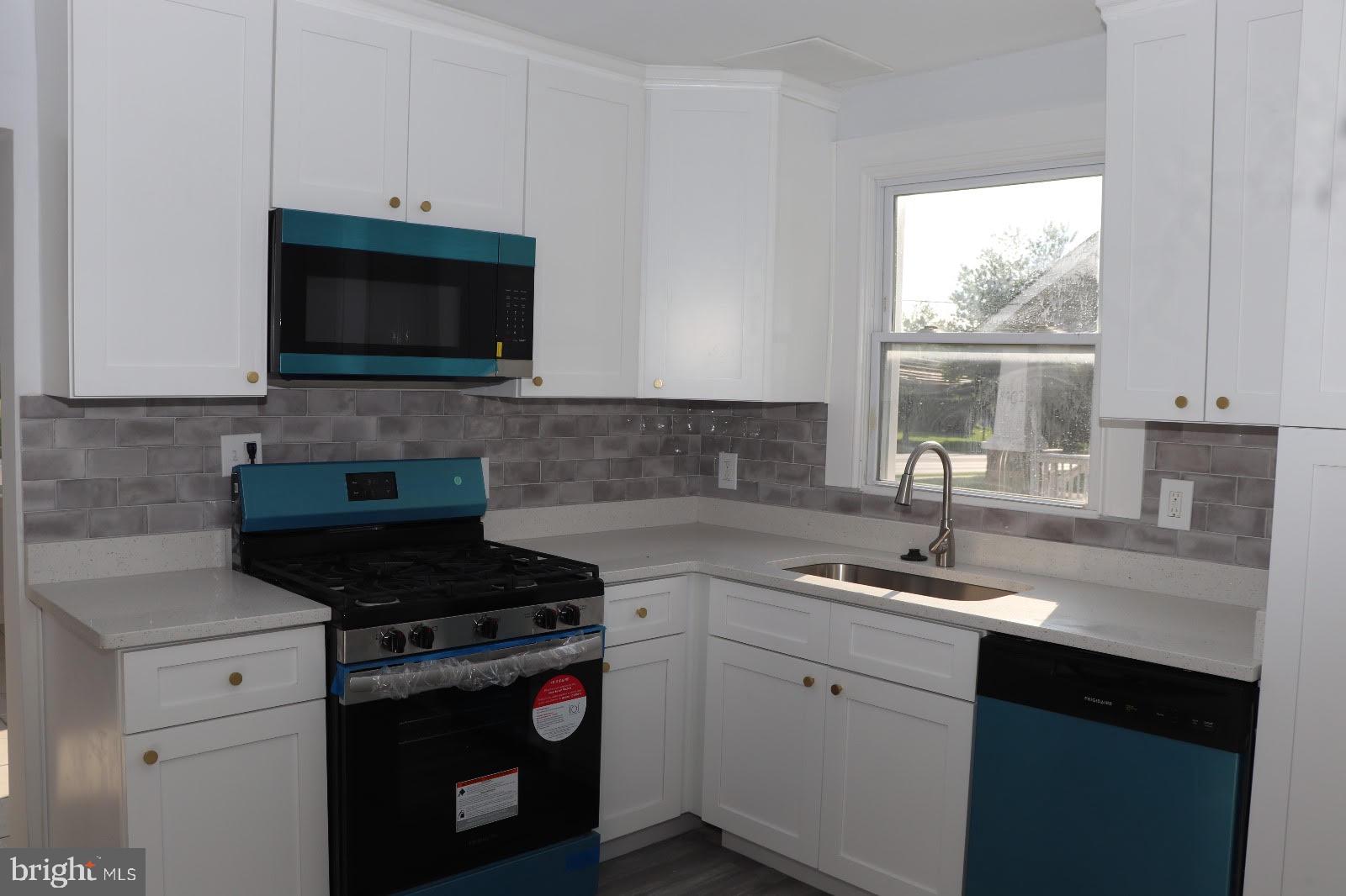 8400 Liberty Road Baltimore, MD 21244 - Photo 16 of 32 a kitchen with a sink stove and microwave