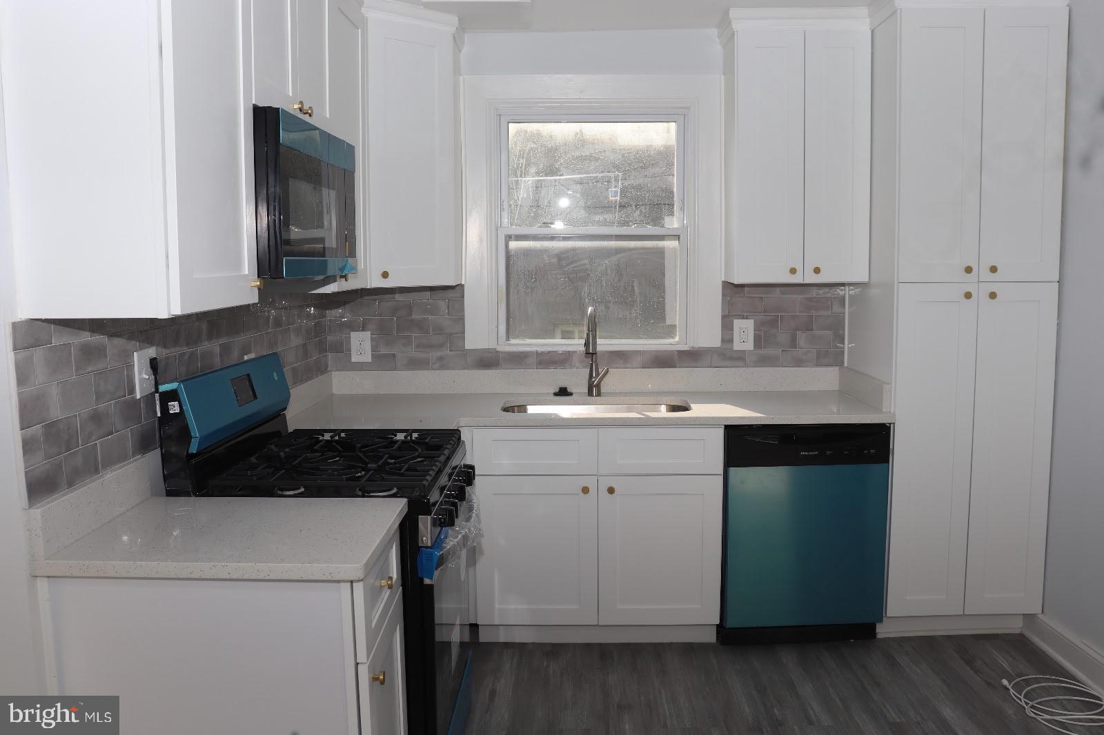 8400 Liberty Road Baltimore, MD 21244 - Photo 2 of 32 a kitchen with a sink stove and cabinets