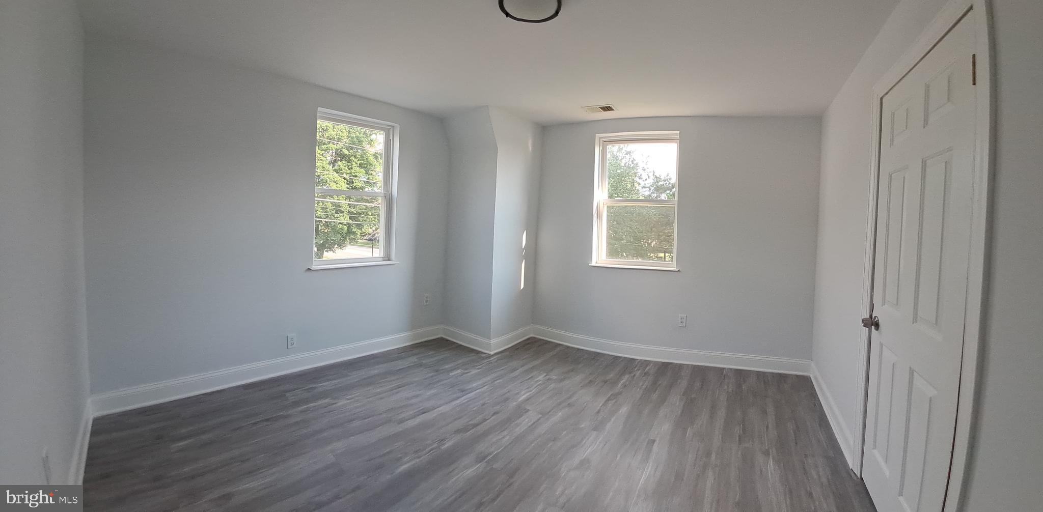 8400 Liberty Road Baltimore, MD 21244 - Photo 24 of 32 an empty room with wooden floor and windows