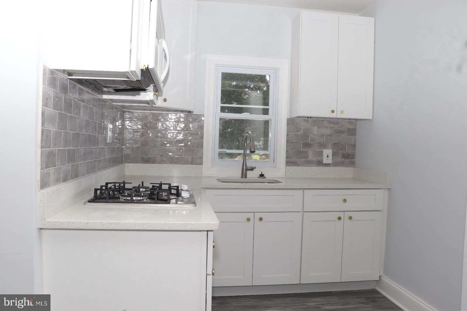 8400 Liberty Road Baltimore, MD 21244 - Photo 27 of 32 a kitchen with a sink a stove and cabinets