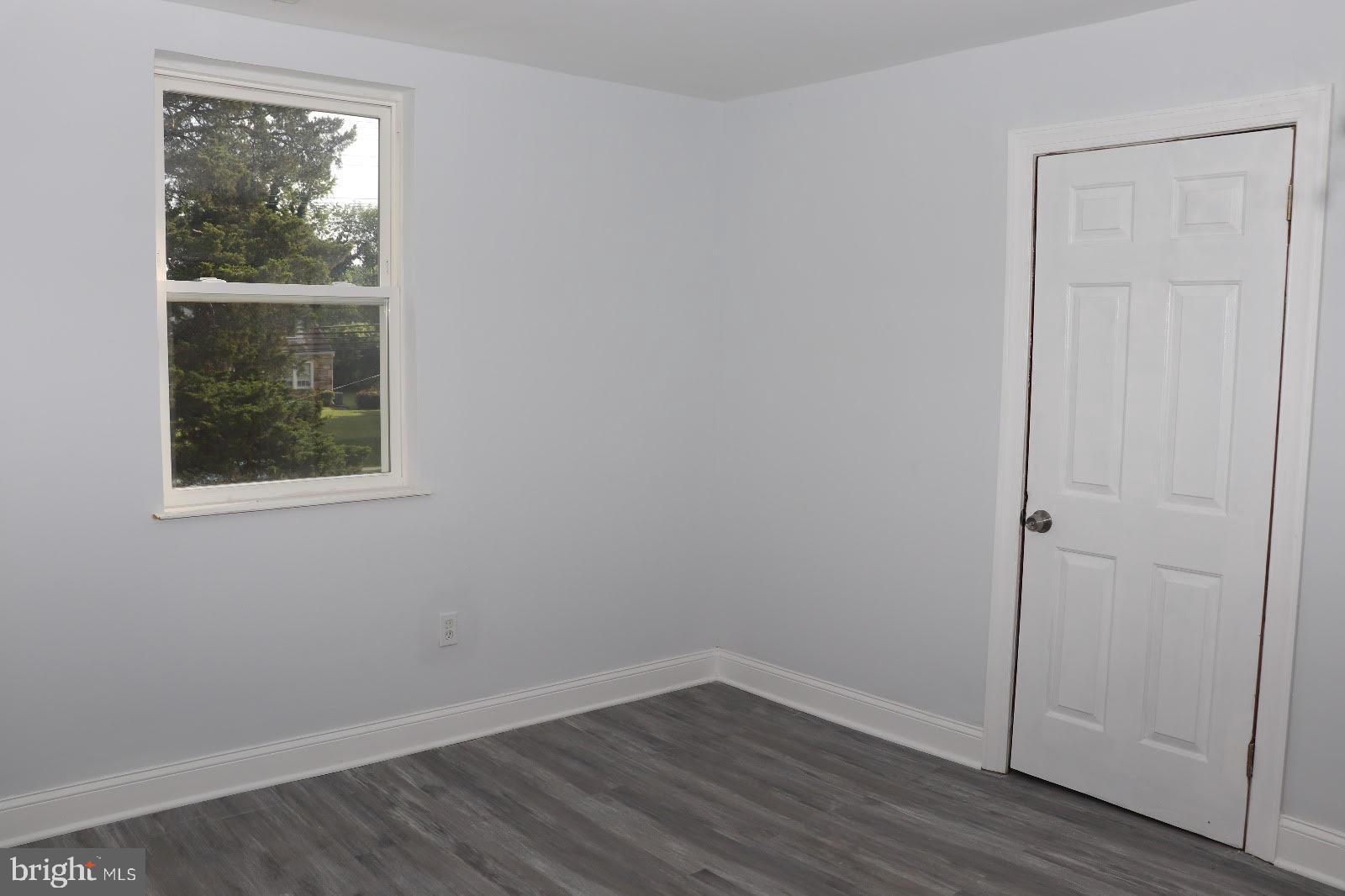 8400 Liberty Road Baltimore, MD 21244 - Photo 4 of 32 a view of an empty room with wooden floor and a window