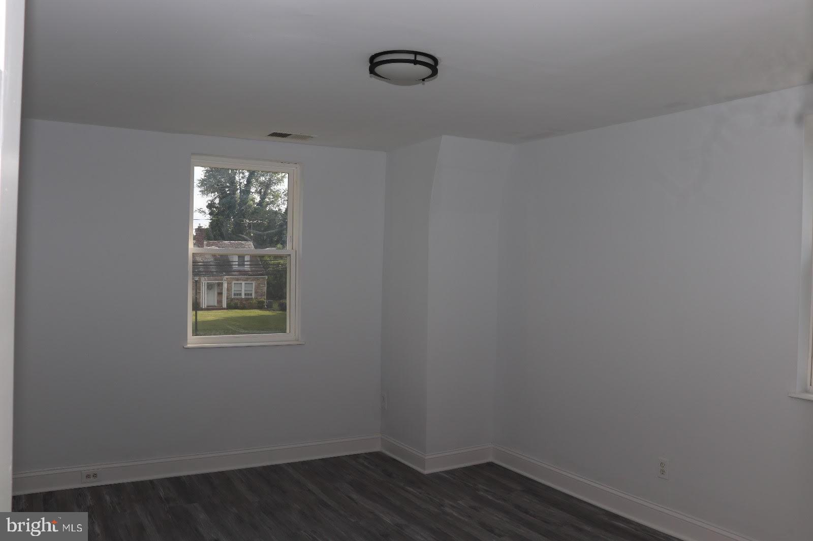 8400 Liberty Road Baltimore, MD 21244 - Photo 6 of 32 a view of an empty room with wooden floor and windows