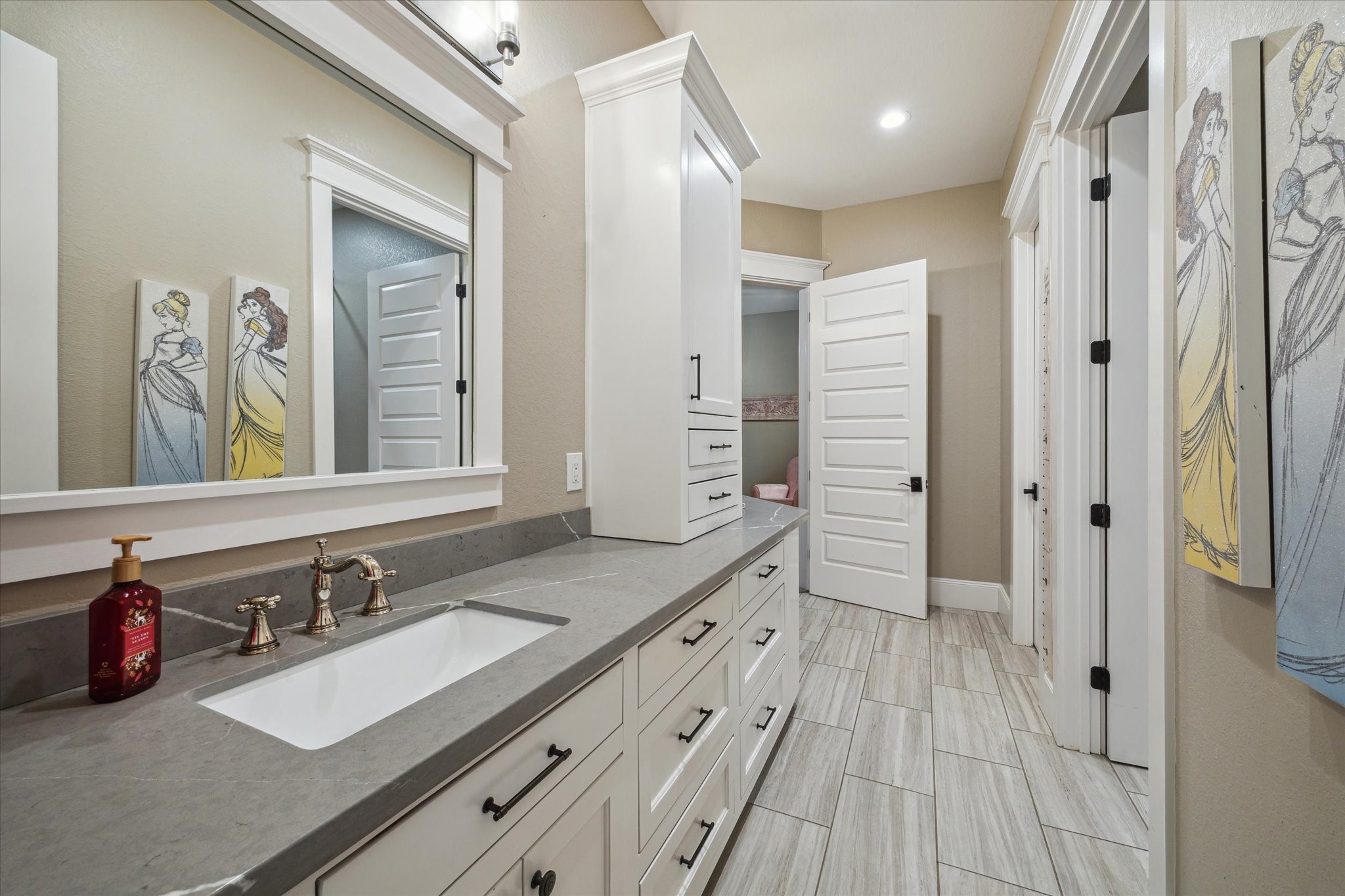 1255 Bronco Trail Angleton, TX 77515 - Photo 23 of 50 The Hollywood bathroom, conveniently located between bedrooms 2 and 3, is designed for both style and functionality. It features double sinks with custom cabinetry, a separate tub and shower combination with custom tilework, and is thoughtfully designed to be wheelchair accessible, ensuring comfort and ease for all.