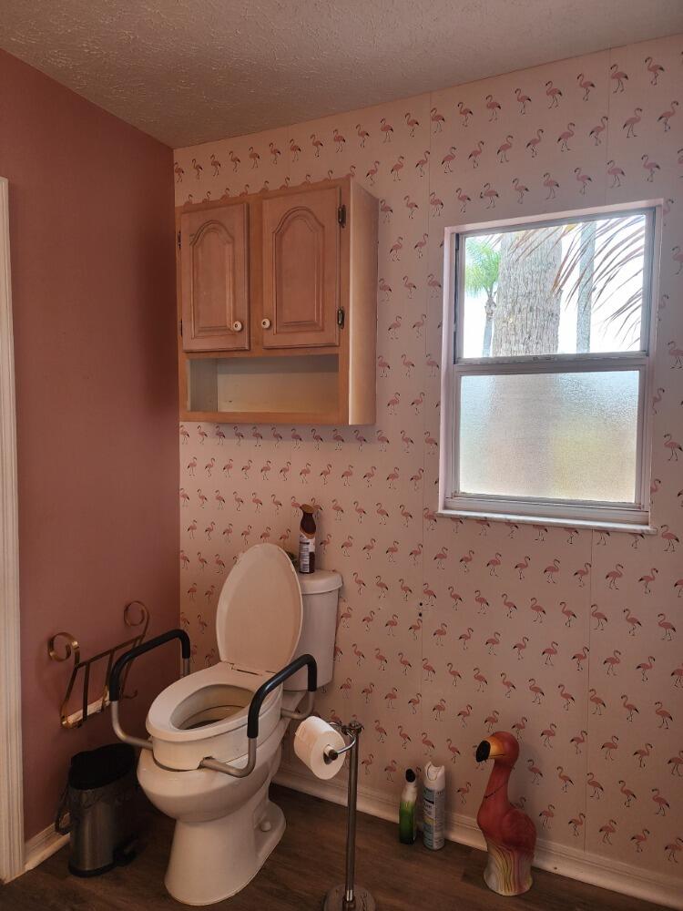 1177 Lisa Lane Okeechobee, FL 34974 - Photo 11 of 22 a bathroom with a toilet sink and mirror