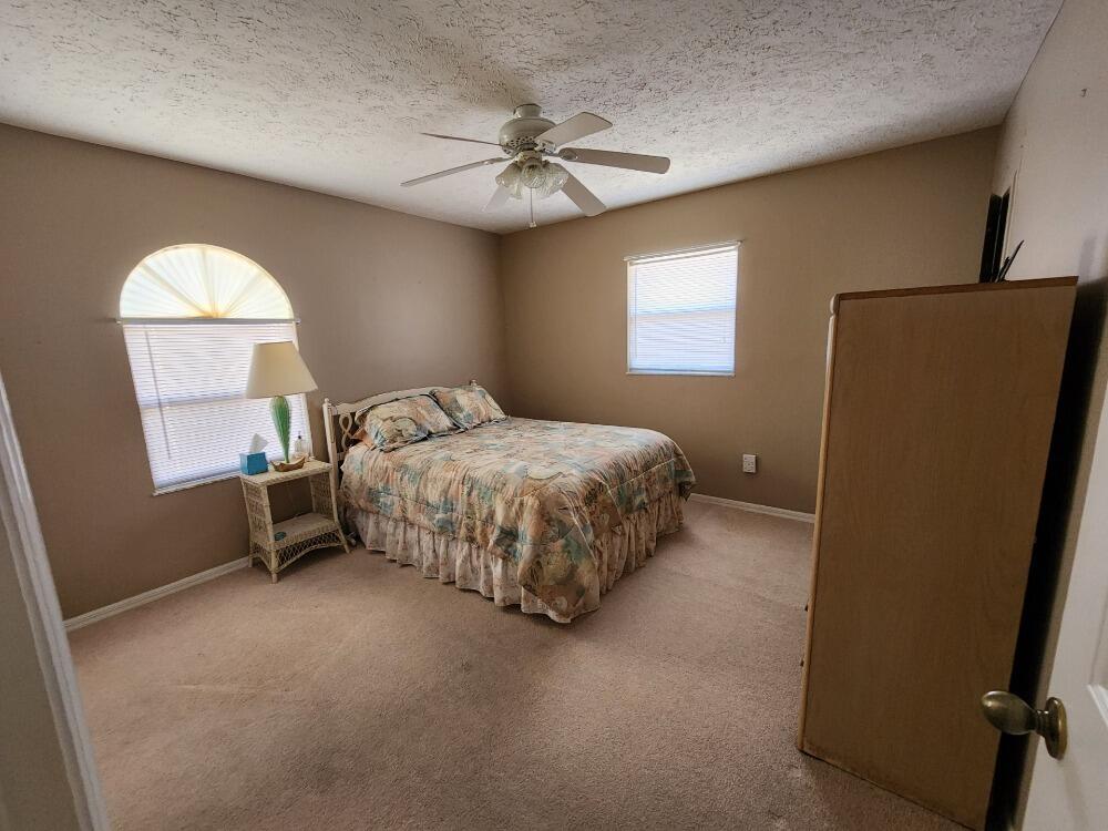 1177 Lisa Lane Okeechobee, FL 34974 - Photo 15 of 22 a bedroom with a bed and a window