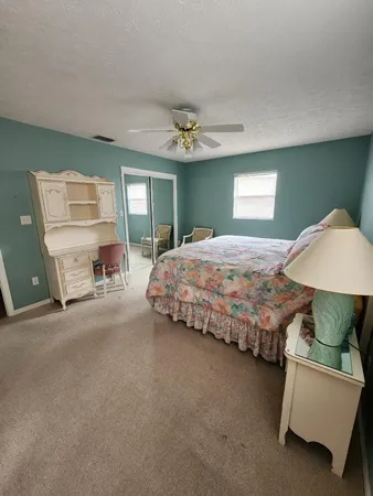 a bedroom with bed and window