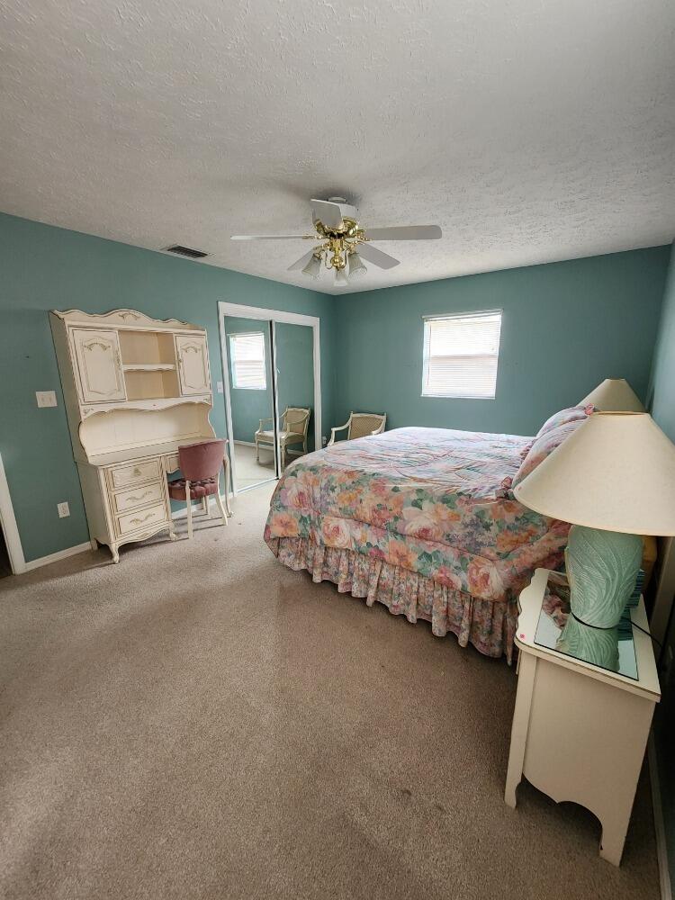 1177 Lisa Lane Okeechobee, FL 34974 - Photo 8 of 22 a bedroom with bed and window