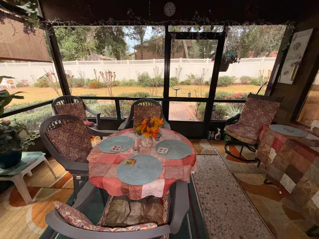 a living room with furniture and a floor to ceiling window