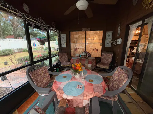 a view of a dining room with furniture large windows and wooden floor