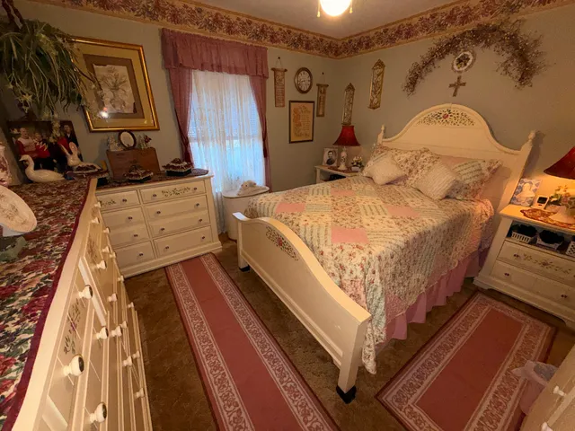 a bed sitting in a bedroom next to a window