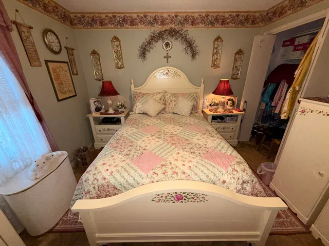 a bed sitting in a bedroom next to a window