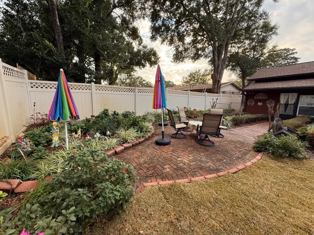 a view of a backyard with sitting area and slide