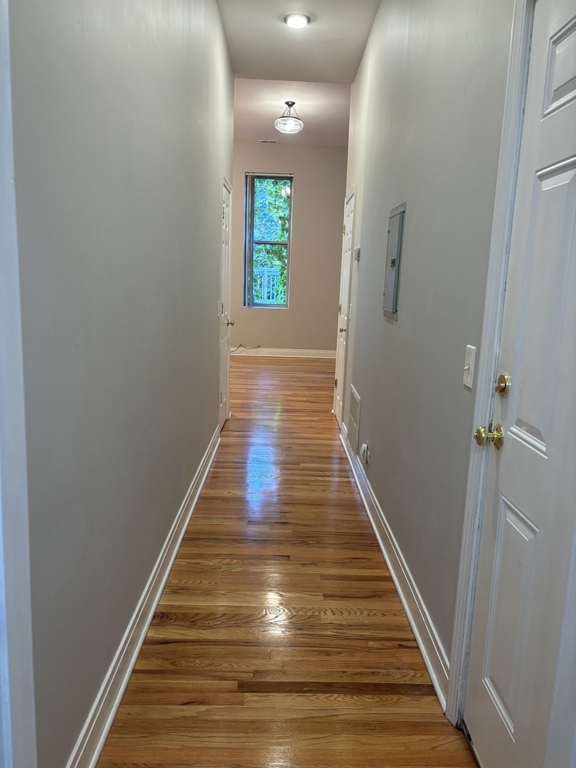 2002 West Chicago Avenue, Unit 2R Chicago, IL 60622 - Photo 11 of 17 a view of a hallway with wooden floor and staircase