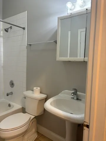 a white toilet sitting next to a bathroom sink