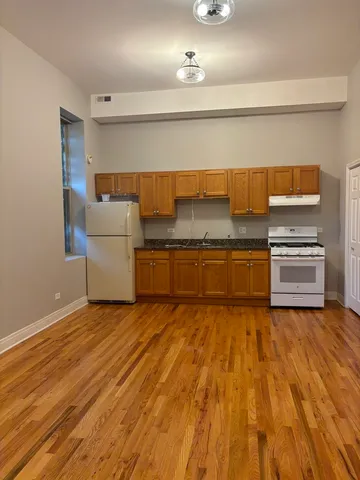 a view of a kitchen with a sink and a stove top oven