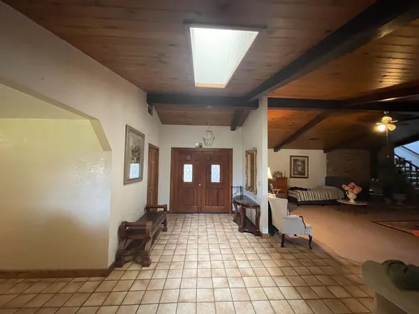 a lobby with furniture and a rug