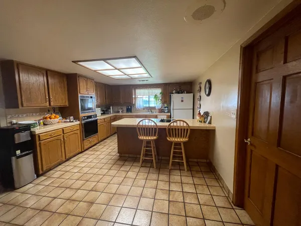 a kitchen with granite countertop a sink cabinets and stainless steel appliances