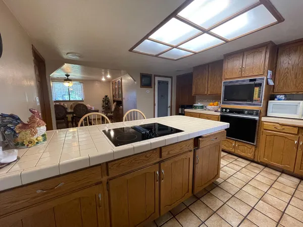 a kitchen with stainless steel appliances wooden cabinets a sink and a stove