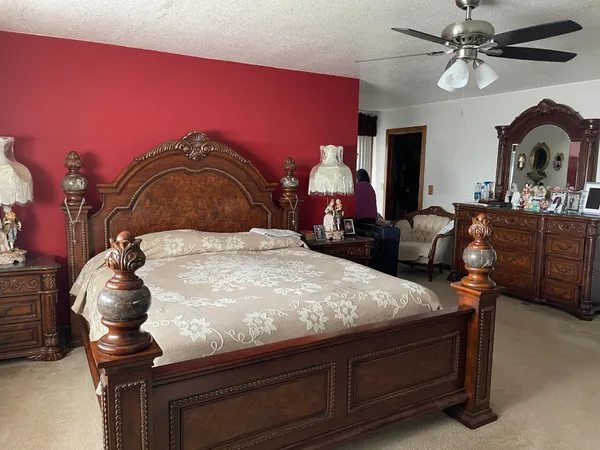 a bedroom with a bed and dresser