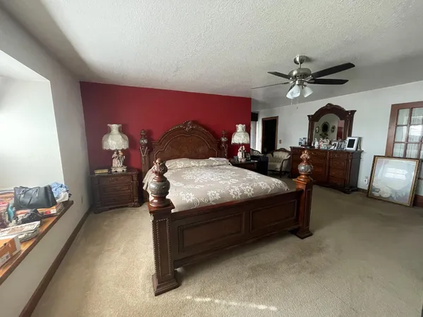 a bedroom with bed and window