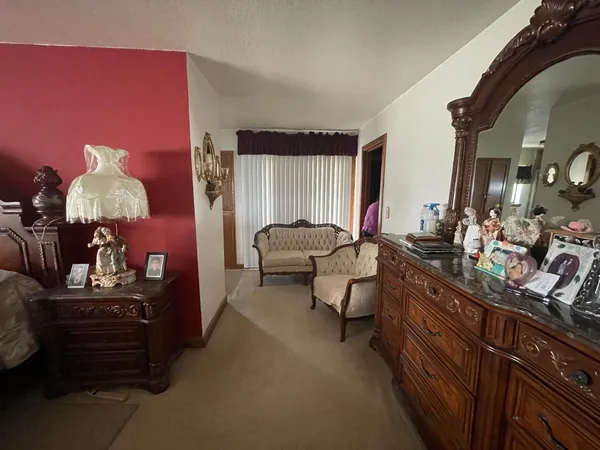 a living room with furniture and a lamp