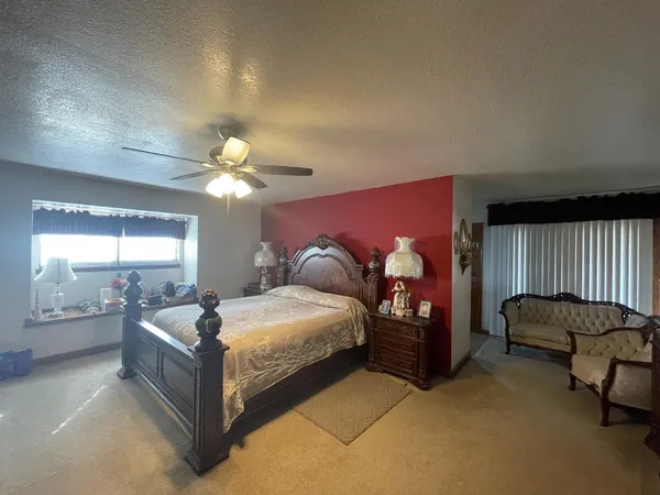 a bedroom with a bed and window