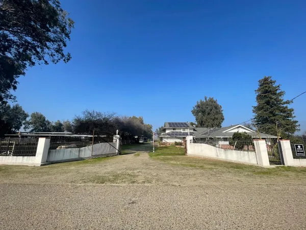 a view of a house with swimming pool and sitting area
