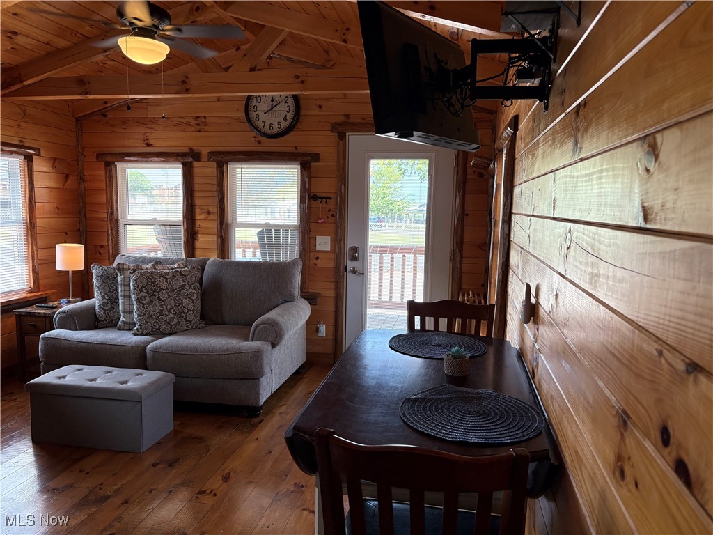 5919 Lake Road West, Unit 7 Ashtabula, OH 44004 - Photo 10 of 29 Living area featuring wooden walls, hardwood / wood-style flooring, wood ceiling, and a ceiling fan